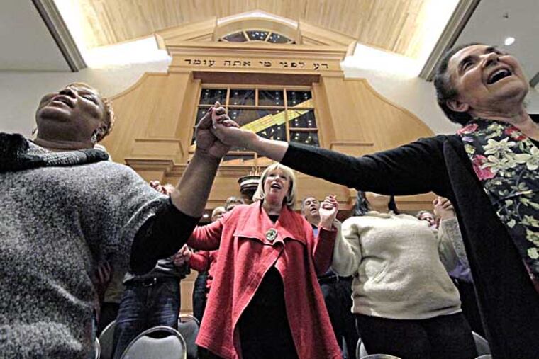 (L-R) Connie Clary of Plainfield, NJ, Sharla Feldscher of Cherry Hill (2nd row center) and Marcy Partnow of Moorestown sing during Unity Choir rehearsal at Cherry Hill's M'kor Shalom temple on January 16, 2014. Blending the voices of Cherry Hill's M'kor Shalom temple and a number of African American Baptist congregations in SJ into the "Unity Choir," which has MLK Day-related performances scheduled. ( ELIZABETH ROBERTSON / Staff Photographer )