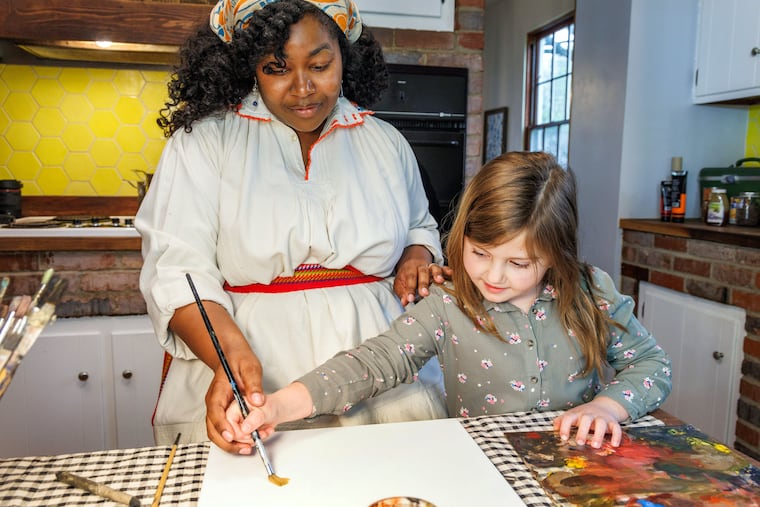 In a publicity photos released by the Pittsburgh Opera, Lauryn Davis (Momma) and Ellis Kozar (Young Mona) paint together in their kitchen in a flashback scene.