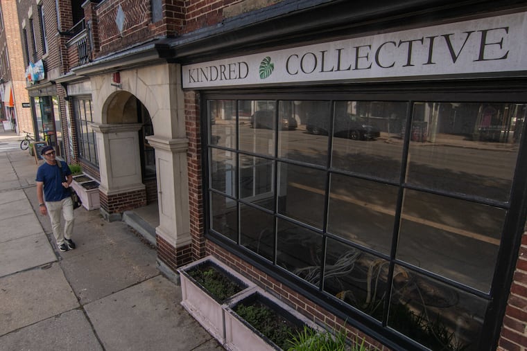 A man walking past 836 W. Lancaster Ave. in Bryn Mawr, Pa. The shop, formerly Kindred Collective, has since been turned into The Bryn Mawr Buttery. The building is one of five listed for sale by developer Tim Rubin.