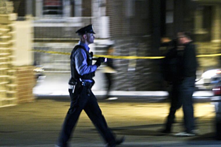 Police investigate the crime scene on Tuesday Jan. 10, 2012, where three 14-year-old youths and a 16-year-old were shot inside a vehicle in an alley in the Juniata section of Philadelphia. (For the Daily News/ Joseph Kaczmarek)