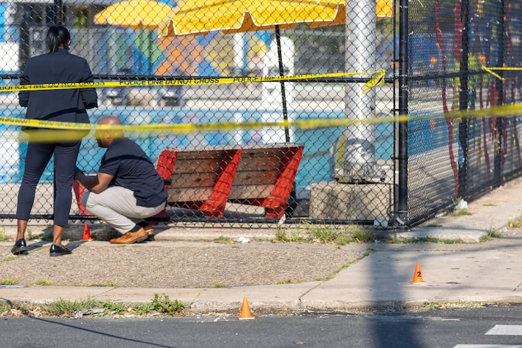 Evidence cones outside Christy Recreation Center at 56th and Christian Street after a shooting on Wednesday.