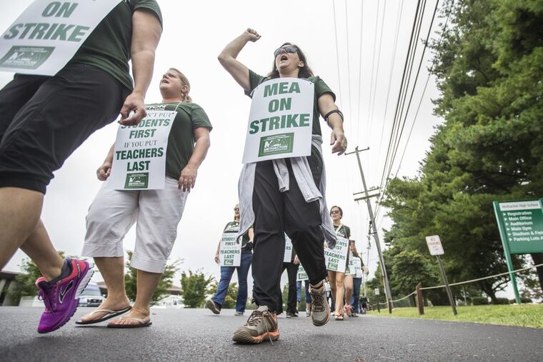 Teachers, counselors, librarians, speech therapist and other members of the Methacton Eduction Association march the picket line in front of the Methacton School District office in Eagleville, PA on Monday September 18, 2017.