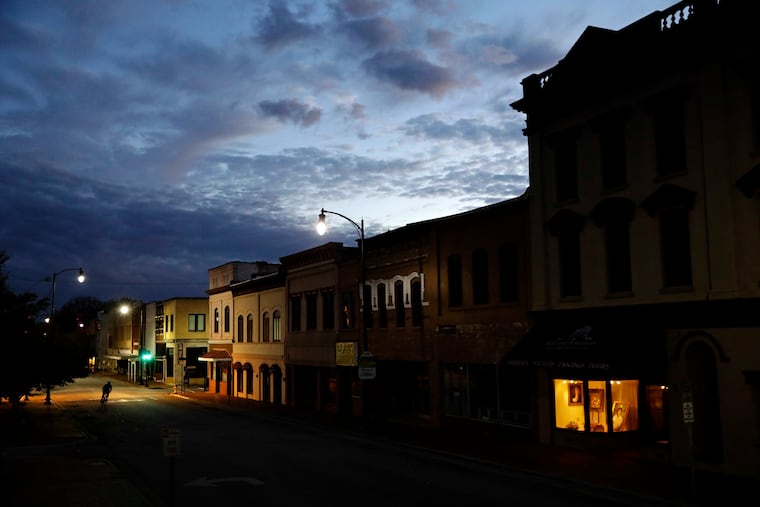 In this Oct. 28, 2017, file photo the storefront window of a portrait studio is lit up along a downtown street at dusk in Lumberton, N.C. Cash is one of the most important indicators for the health of small businesses. AP Photo/David Goldman, File