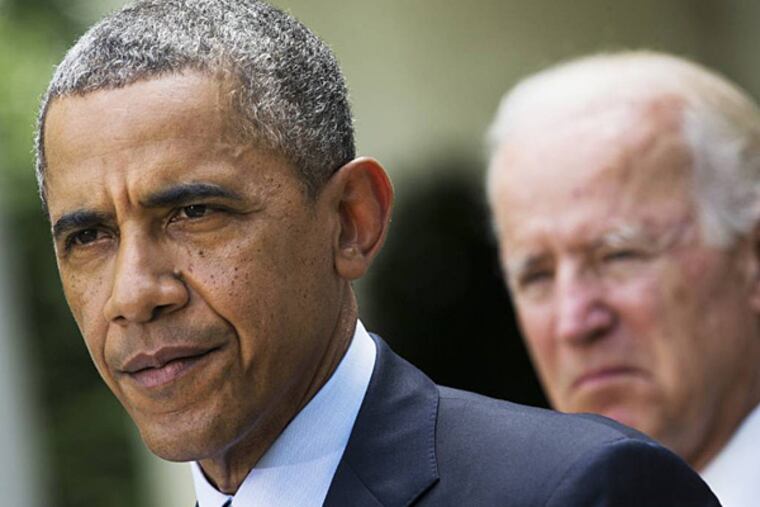 FILE - This June 30, 2014 file photo shows President Barack Obama, accompanied by Vice President Joe Biden, pausing while making a statement about immigration reform, in the Rose Garden of the White House in Washington. (AP Photo/Jacquelyn Martin, File)