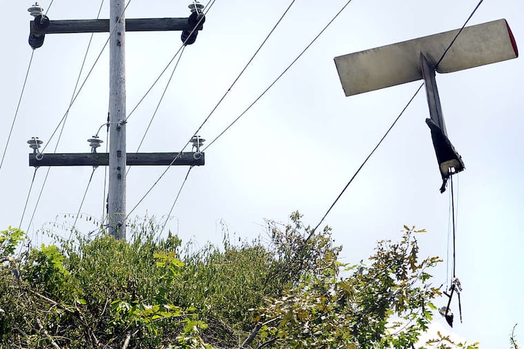 The small plane's tail remained tangled in power lines near Doylestown Airport.