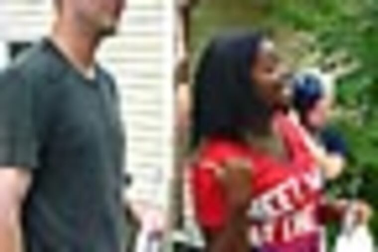 Phillies "super phan" Corinne Hagans introduces her friends and family to starting pitcher Kyle Kendrick. Kendrick stopped by Hagans's Cherry Hill house Saturday morning for a barbecue and room makeover as part of a fan contest. Staff photo by Jonathan Lai