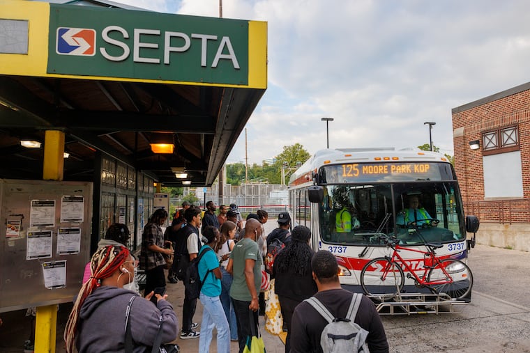 Commuters waiting to board the Route 125 bus at Wissahickon Transportation Center on Monday.
