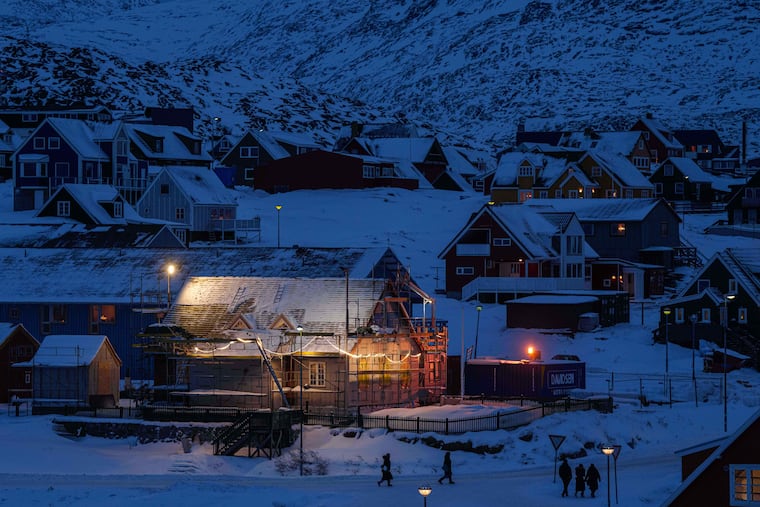 People walk along a street in the downtown area of Nuuk, Greenland, on Tuesday.