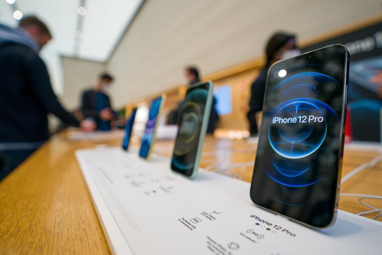 The new iPhone 12 and iPhone 12 Pro on display during launch day on October 23, 2020, in London, England. Apple and Amazon posted disappointing earnings, suggesting that a difficult holiday season is in store for consumers. (Ming Yeung/Getty Images/TNS)