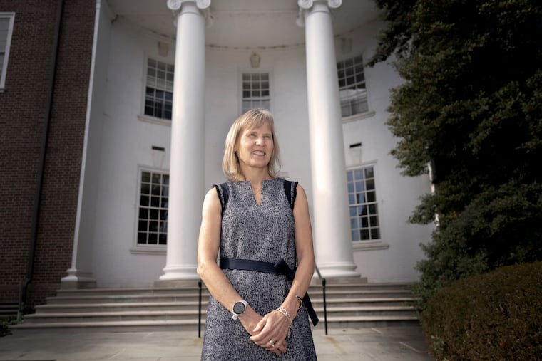 Laura Carlson, president of the University of Delaware, stands on the steps of the administration building.