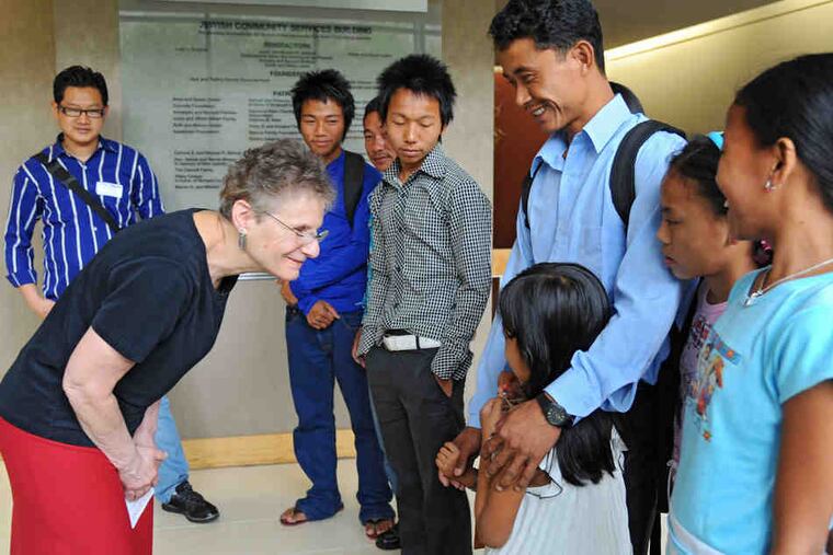 Judith Bernstein Baker, director of HIAS and Council Migration Service of Philadelphia, greets Nepali refugees from Bhutan who have been in the United States less than 24 hours.