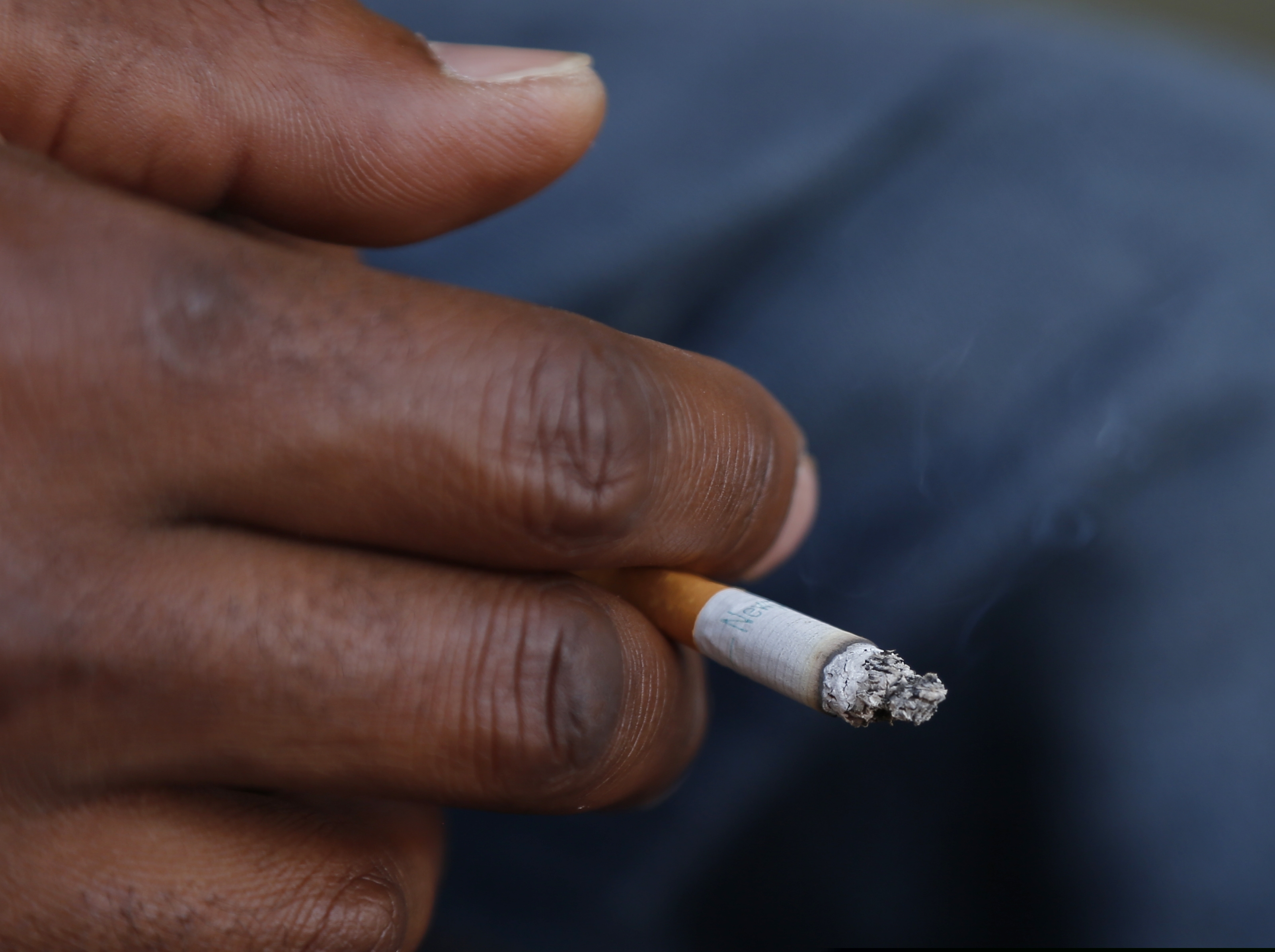 A smoker holds his cigarette outside Oklahoma County Courthouse in Oklahoma City.