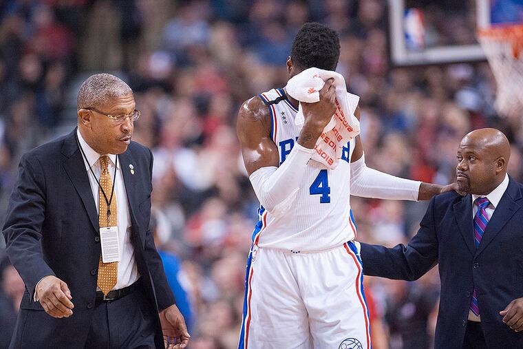 Philadelphia 76ers forward Nerlens Noel (4) is helped off the court injured after a heavy fall against Toronto Raptors in the third quarter at Air Canada Centre. The Raptors beat the 76ers 96 - 76.
