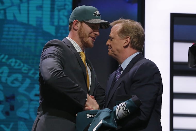 Carson Wentz shakes hands with NFL commissioner Roger Goodell after being taken by the Eagles with the second pick in the 2016 Draft. Moments earlier, the Rams had selected Jared Goff. (AP Photo/Charles Rex Arbogast)