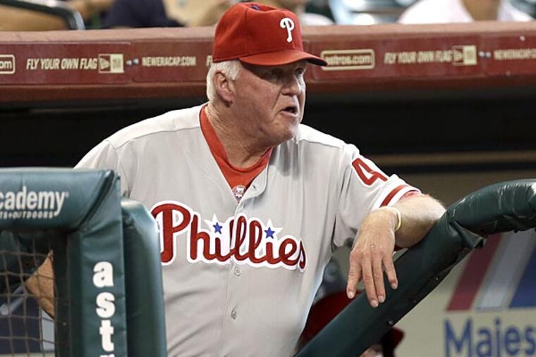 Philadelphia Phillies manager Charlie Manuel watches from the dugout during the second inning of a baseball game against the Houston Astros Sunday, Sept. 16, 2012, in Houston. (AP Photo/David J. Phillip)