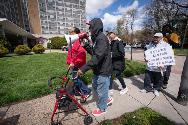 Earnest Headen leads his fellow residents with a bullhorn while protesting the living conditions at Brith Sholom House apartments, in Philadelphia, on Friday, April 12, 2024.