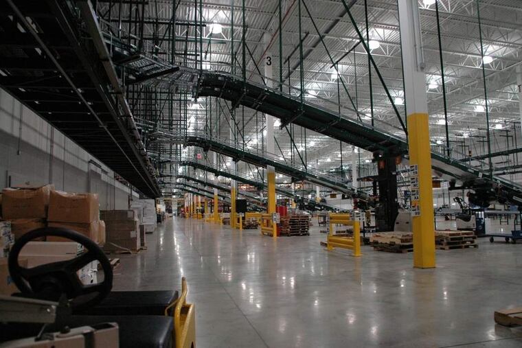 At a distribution facility, boxes filled with orders for AmerisourceBergen Corp. customers descend conveyor belts, headed for loading docks. The firm was called out by New York's attorney general for allegedly failing to report suspicious opioid orders.