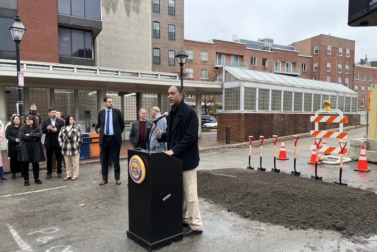 Mike Carroll, Philadelphia's deputy managing director for Transportation and Infrastructure, speaks Tuesday at the groundbreaking of the Old City Market Street Improvement Project. To his immediate left, Councilmember Mark Squilla and Bill Marrazzo, chair of the nonprofit Independence Historical Trust, confer as Job Itzkowitz, executive director of Old City District, looks on.
