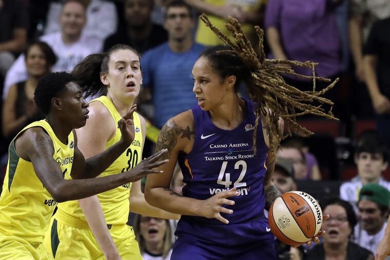 Phoenix Mercury's Brittney Griner (42) is doubled-teamed by Seattle Storm's Natasha Howard, left, and Breanna Stewart during the first half of Game 5 of a WNBA basketball playoffs semifinal, Tuesday, Sept. 4, 2018, in Seattle. (AP Photo/Elaine Thompson)