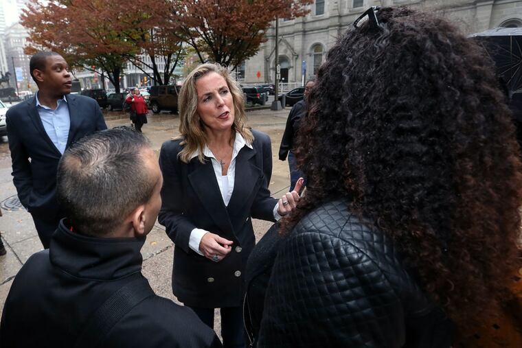 Democratic Senate candidate Katie McGinty talks to union members at a City Hall rally urging a boost in the minimum wage. She has big-name support; now the task is winning over the public.