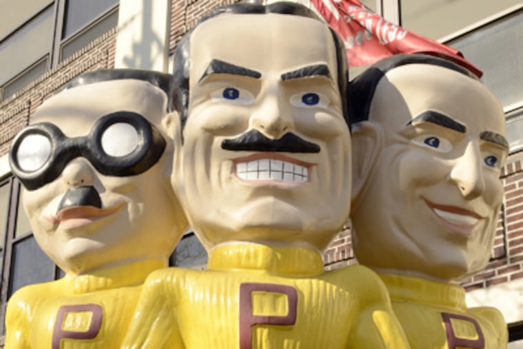 Statue of Manny, Moe & Jack outside Pep Boys' Philadelphia headquarters, above, and a nearby store, below, both on Allegheny Avenue. (Tom Gralish / Staff Photographer)