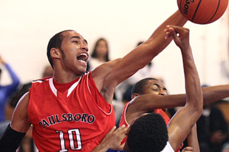 Paulsboro's Xavier Lundy blocks a shot by Westampton Tech's Marquel Davis. (Lou Rabito/Staff)