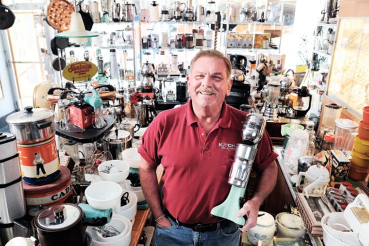 Rich Boris, 63, owner of Kitch-n Collectibles on Ridge Ave., stands amid his wares -- restored old appliances which are celebrated and purchased by consumers who aren't impressed with the modern appliances. ( CLEM MURRAY / Staff Photographer )