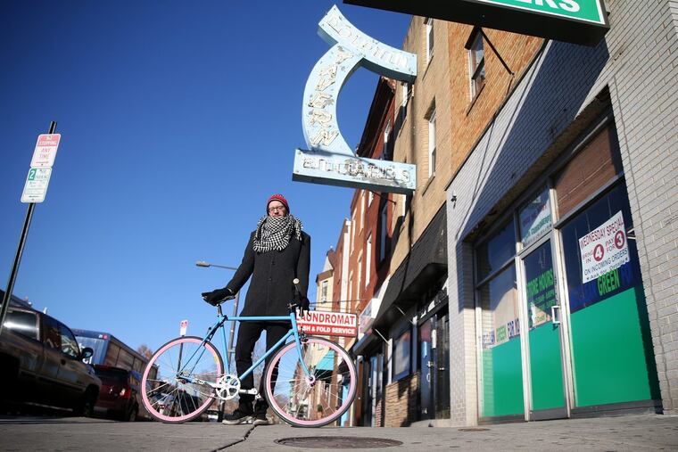Josa Lazas stands for a portrait with his bicycle outside the Dolphin Tavern along Broad Street on Wednesday, Dec. 13, 2017.