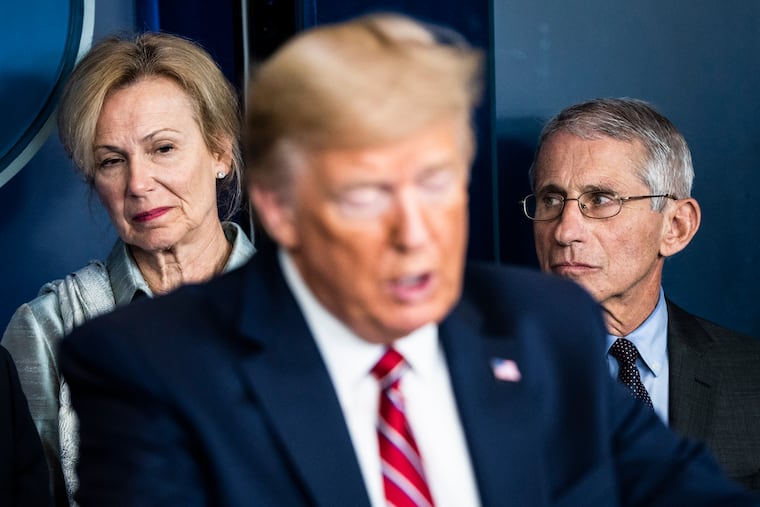 Deborah Birx and Anthony Fauci listen as President Donald Trump speaks during a briefing in response to the coronavirus at the White House on March 20. MUST CREDIT: Washington Post photo by Jabin Botsford