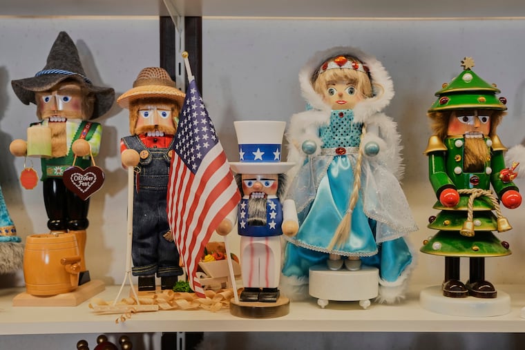 An Uncle Sam nutcracker with an American flag, center, stands between other nutcrackers at the Steinbach-Volkskunst nutcracker factory in Marienberg, Germany, Tuesday, April 15, 2025.
