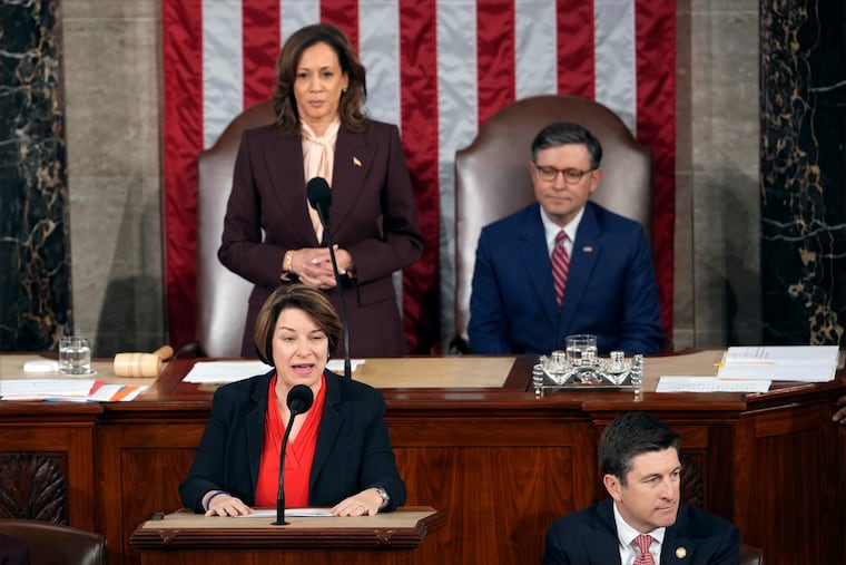 Vice President Kamala Harris and House Speaker Mike Johnson of La., listen as Sen. Amy Klobuchar, D-Minn., reads a certification during a joint session of Congress to confirm the Electoral College votes, affirming President-elect Donald Trump's victory in the presidential election.