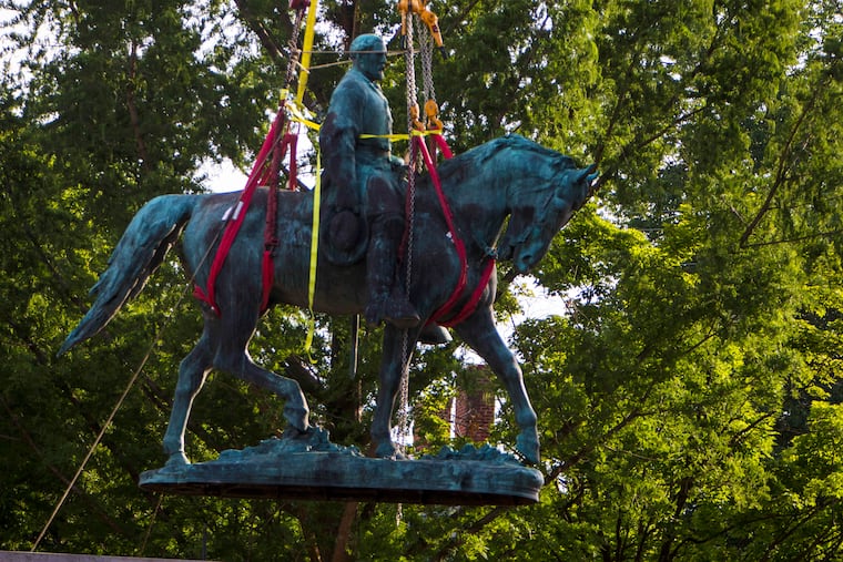 Workers remove the monument of Confederate General Robert E. Lee on Saturday, July 10, 2021 in Charlottesville, Va. The removal of the Lee statue follows years of contention, community anguish and legal fights.