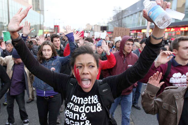 Loren Robinson's shirt at a Philadelphia protest offers a list of black men killed by police.