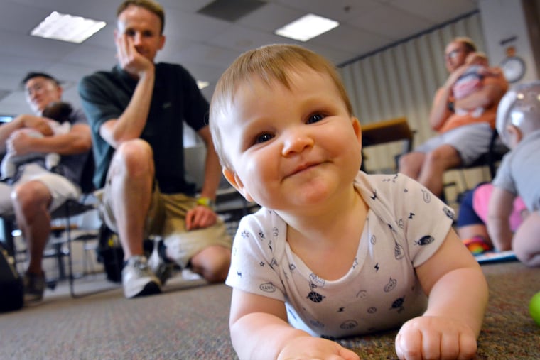 Patrick Clancy crawls along with his father, Jesse, behind him at a meeting of DadLab on Saturday June 2,2018.