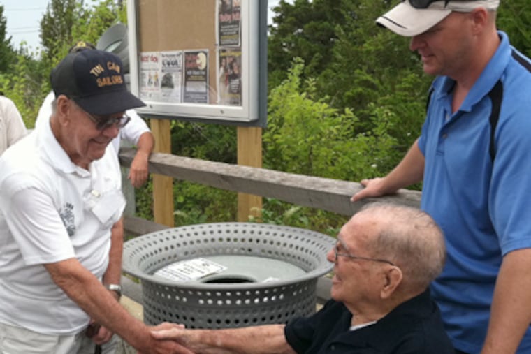 Navy veteran Jim Rodan (left) welcomes Joe Tidwell back to Cape
May. At right is Tidwell's grandson, James Eric Tidwell. (Kevin Riordan / Staff)