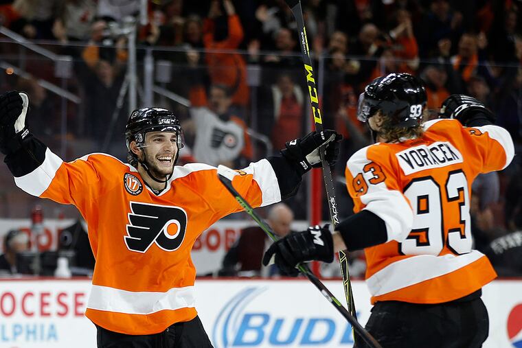 Philadelphia Flyers' Shayne Gostisbehere, left, celebrates with Jakub
Voracek after scoring the game-winning goal during overtime of an NHL
hockey game against the Carolina Hurricanes, Monday, Nov. 23, 2015, in Philadelphia. Philadelphia won 3-2 in overtime.