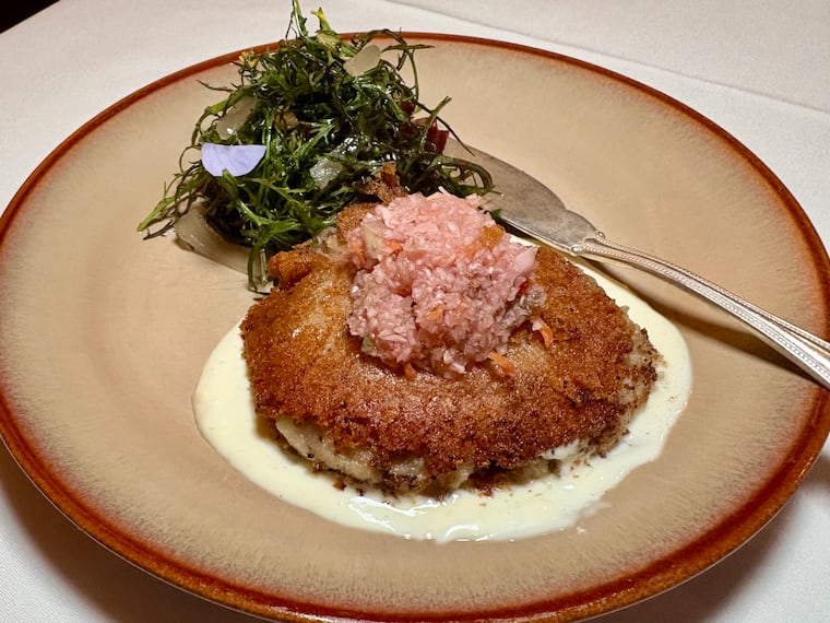 Shad cakes, made from fish cooked on a cedar plank, are served at Elwood in Fishtown with lemon aioli, pepper hash, and greens dressed in warm bacon vinaigrette.