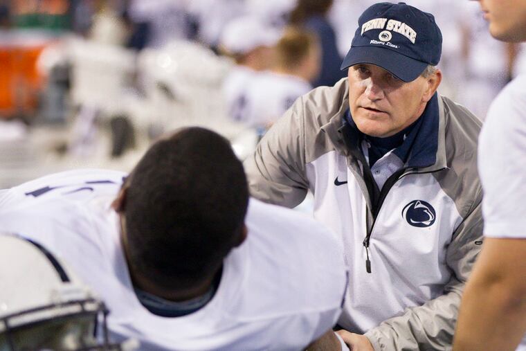 Penn State team physician Scott Lynch aiding guard Chasz Wright during a game against Maryland on Oct. 24, 2015.
