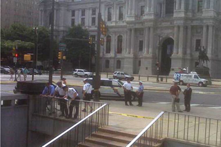Police gather at the scene where two officers shot and killed a homeless man who, police said, lunged at them with a utility knife. (Matt Spolar / Staff)