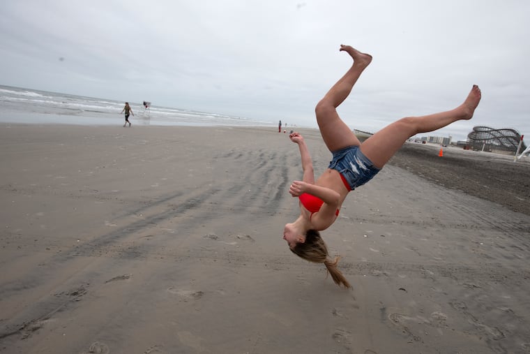 Cecilia Dalfonso of Glassboro, NJ does a flip on the beach in Wildwood, NJ on May 25, 2020. A gray windy morning would later turn into a perfect sunny day.