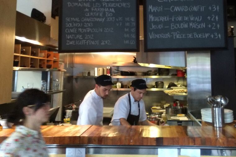 The open kitchen bustles at Le Clocher Penché, a sunny corner bistro with a clear focus on local wines and ingredients.