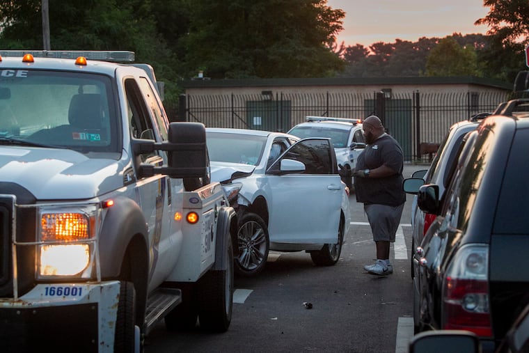 Philadelphia police remove a vehicle from the scene of a homicide at Ramona and I Streets early Tuesday morning.