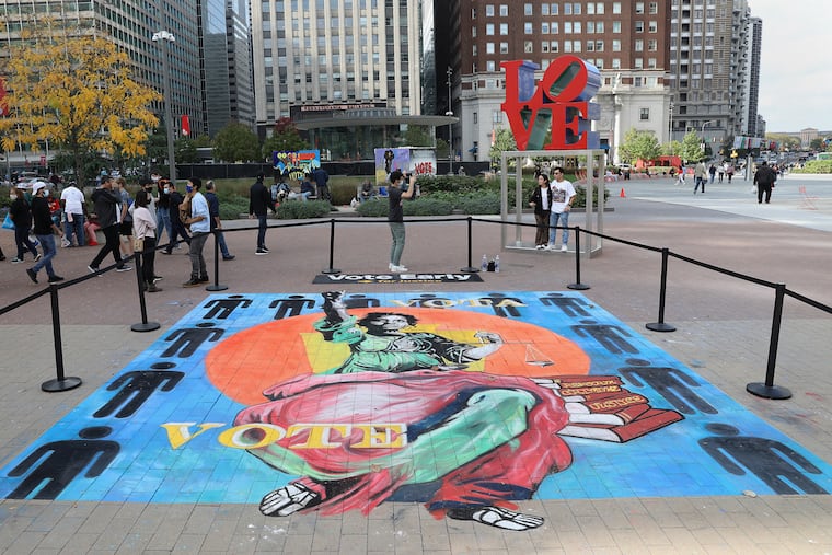 A mural by chalk artist Bill Strobel at Love Park in Center City Philadelphia encourages people to vote early on Saturday, Oct. 24, 2020. The artwork is part of a "Vote Early Day" campaign by MTV and others to raise awareness of early voting options ahead of election day Nov. 3.