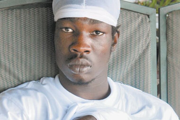 Leroy Lewis, 19, sits on the porch of his home on in Juniata Park. (Peter Tobia/Staff Photographer)