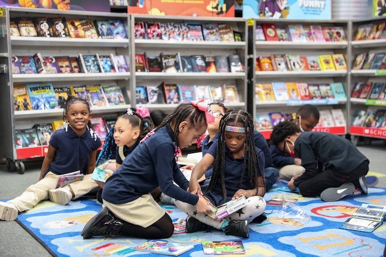 First graders look through their new books.