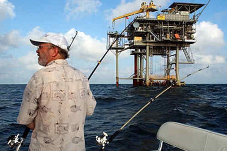 A fisherman plies the waters of the Gulf of Mexico near a natural-gas well near Gulf Shores, Ala. President Obama's plan would open an area off the coast of Virginia to exploration. (Dave Martin / Associated Press)