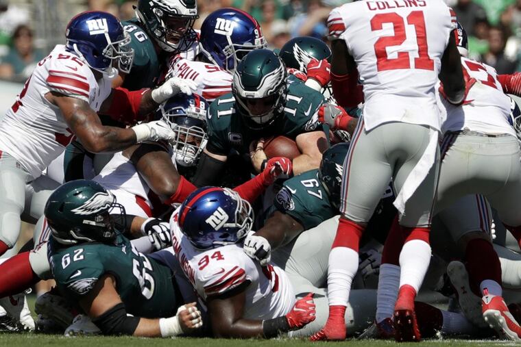 Eagles’ Carson Wentz rushes for a first down during the first half against the Giants.