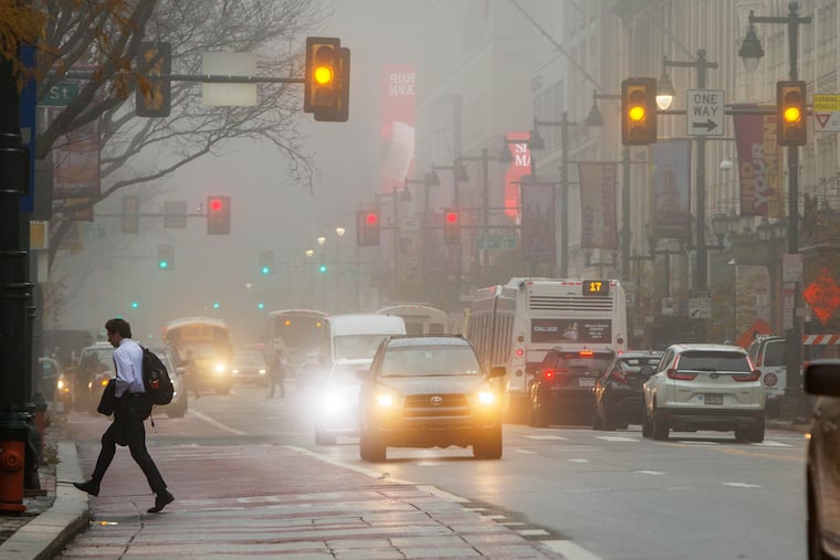 The fog on cat-like feet prowls the area abound 7th and Market in Centery City. Dense fog was common throughout the area Tuesday morning. It will give way to rain later