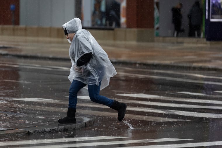 Pedestrians cross Fifth Street in Philadelphia, Pa., on Tuesday, Jan. 9, 2024.