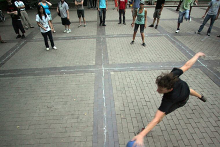 Dallas Conrad, 21, of Philadelphia, plays four square in Rittenhouse Square, where the game was a Monday-night summer ritual for three years. (David Swanson / Staff Photographer)